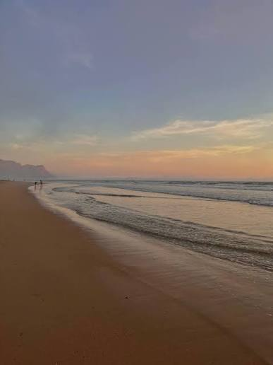 Early morning light over the beach, with the mountains faint in the distance