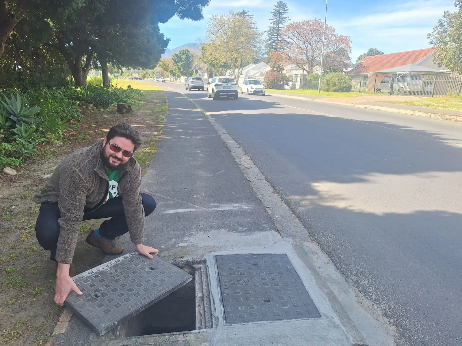 Rory Atkinson inspecting sewerage infrastructure on a street in Somerset West